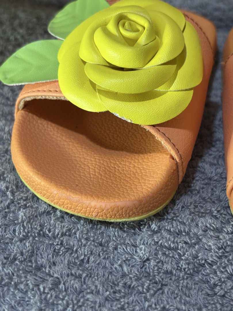 Janie and Jack Yellow Rose Sandals (Category: Babies & Kids Fashion) located in Manila. Submitted by wardrobeinmnl (Listing ID 1467893400, Image 3). Description: - Brand: Janie and Jack (Swim Line) - Size: 9 - Color/Design: Pink slides with 3D yellow rose and green leaves - Features: Textured footbeds and non-slip soles - Condition: Good, with minor sticker residue underneath soles - Origin: Made in China.