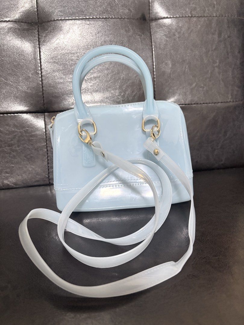 Jelly Handbag with Removable Strap (Category: Shoulder Bags) located in Quezon City. Submitted by viee04 (Listing ID 1467911015, Image 2). Description: - Color: Light blue - Material: Waterproof silicone (super easy to wipe clean) - Hardware: Gold-tone with top zipper closure - Features: Top handles and matching adjustable/detachable shoulder strap - Size: Compact, ideal for daily essentials, phone, and keys From Thailand bought for 1600php May k