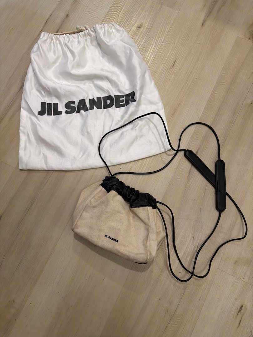 Jil Sander Canvas and Leather Drawstring Crossbody Bag (Category: Cross-body Bags) located in Manila. Submitted by _____car0usell (Listing ID 1467984455, Image 1). Description: Includes dust bag Notable flaking and peeling along the black leather drawstring collar.