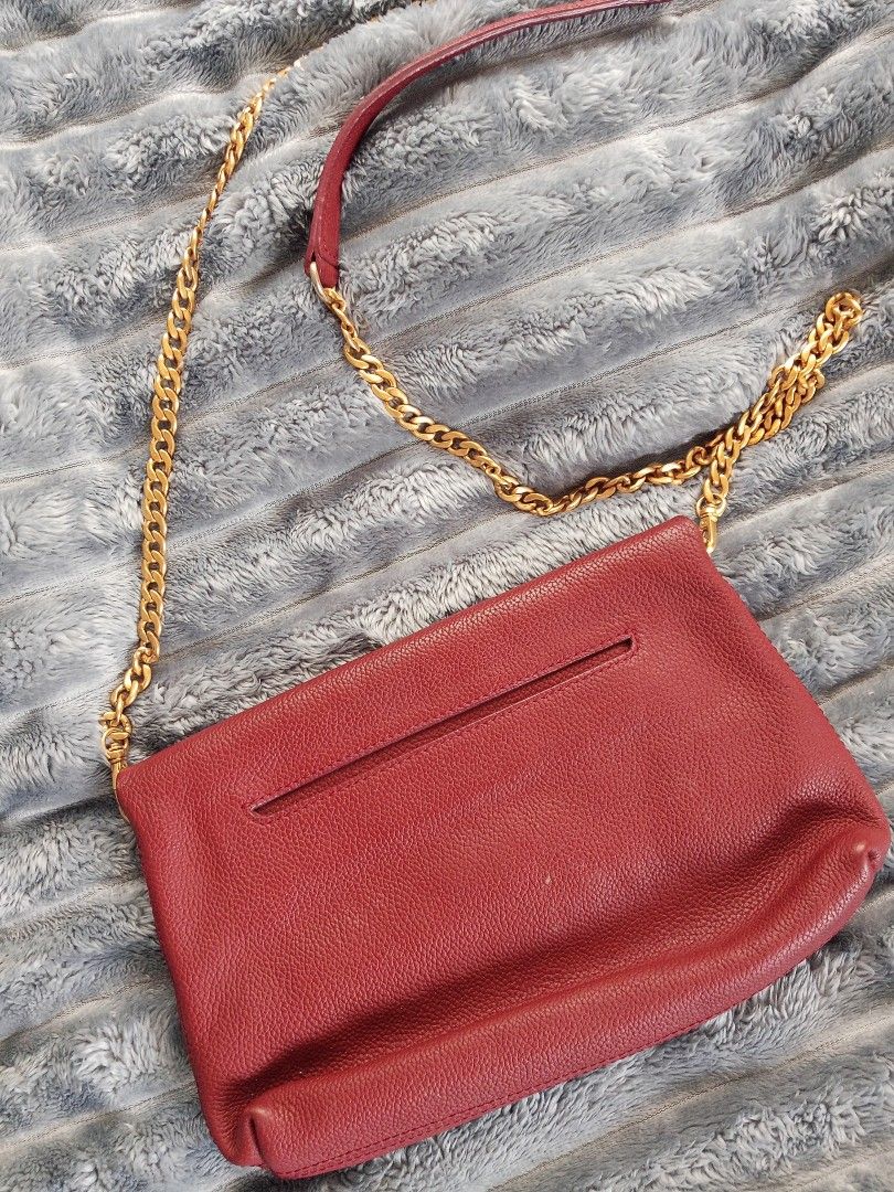Jill Stuart Red Leather Chain Crossbody Bag (Category: Cross-body Bags) located in Zamboanga. Submitted by reg_ukay_shopp (Listing ID 1467851051, Image 2). Description: - Brand: Jill Stuart - Material: Rich red pebbled leather - Hardware: Gold-tone chunky chain strap with leather shoulder guard - Closure: Foldover flap with magnetic snap - Exterior: Convenient front zippered pocket - Interior: Clean lining with structured compartments - Condition