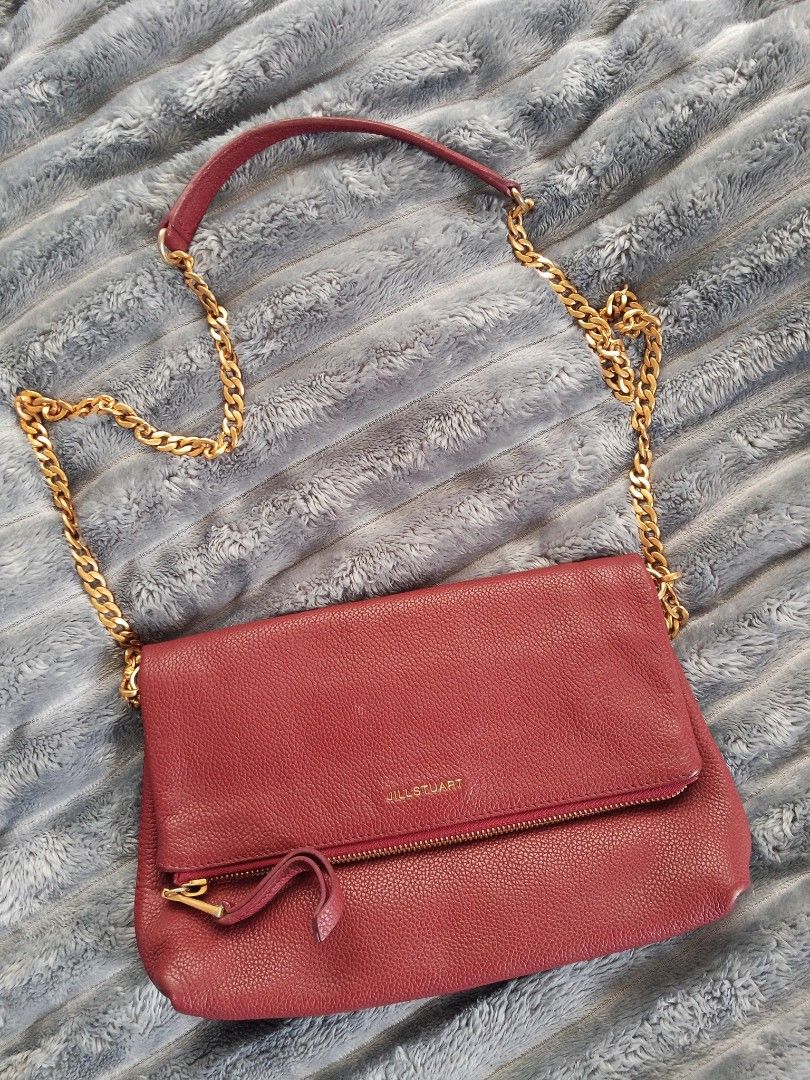Jill Stuart Red Leather Chain Crossbody Bag (Category: Cross-body Bags) located in Zamboanga. Submitted by reg_ukay_shopp (Listing ID 1467851051, Image 1). Description: - Brand: Jill Stuart - Material: Rich red pebbled leather - Hardware: Gold-tone chunky chain strap with leather shoulder guard - Closure: Foldover flap with magnetic snap - Exterior: Convenient front zippered pocket - Interior: Clean lining with structured compartments - Condition