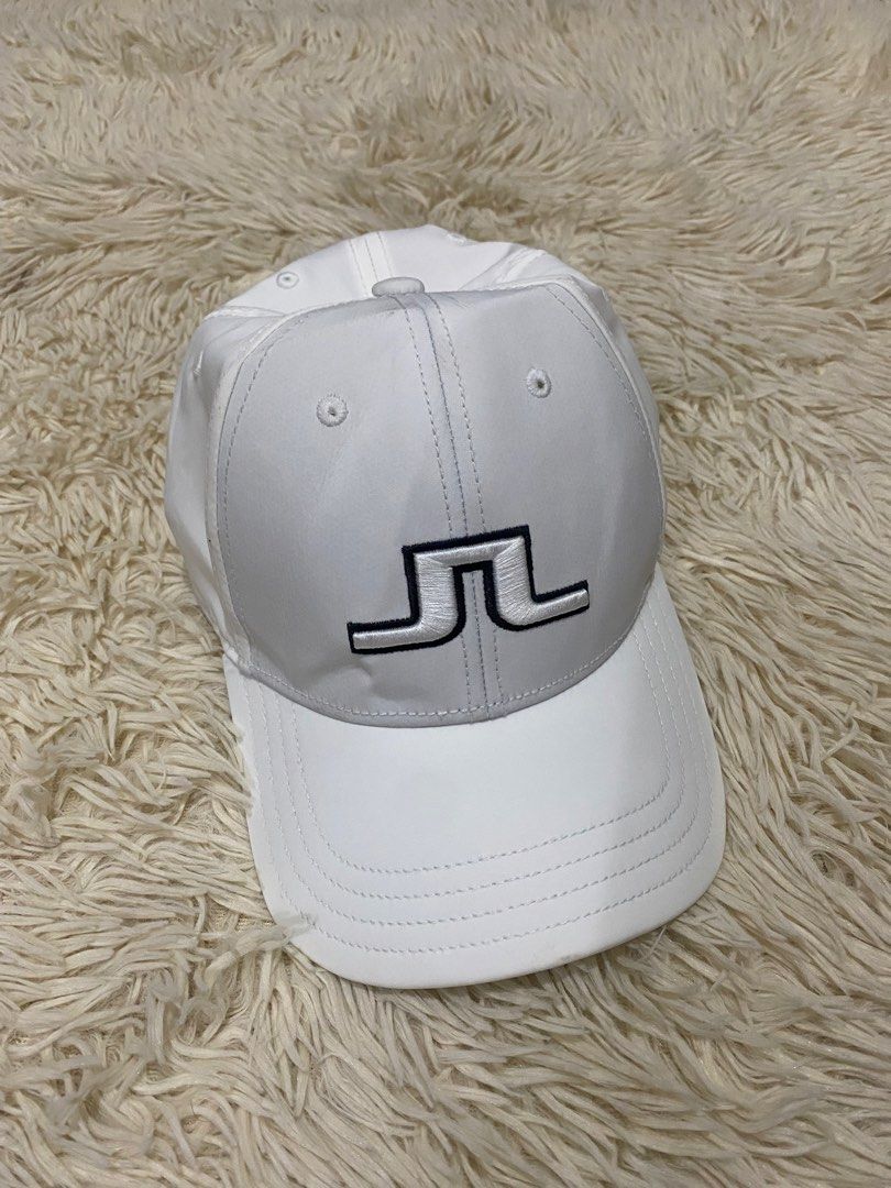 j.lindeberg Angus Tech Stretch Cap White (Category: Caps & Hats) located in Manila. Submitted by switchcity (Listing ID 1467878038, Image 1). Description: - Brand: J.Lindeberg Angus Tech Stretch Cap - Color: Classic White - Logo: Iconic embroidered JL logo on the front - Material: 97% polyester, 3% elastane for a comfortable stretch - Fit: Adjustable metal buckle closure (One size fits most) - Condition: Clean interior lining with proper brand ta