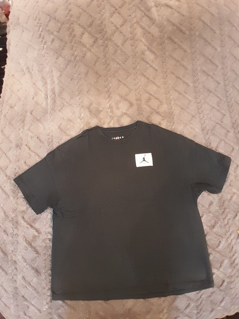 Jordan Black T-Shirt with Jumpman Logo Patch (Category: Tshirts & Polo Shirts ) located in Las Pinas. Submitted by maljun1972 (Listing ID 1467958972, Image 1). Description: - Brand: Jordan - Color: Black - Size/Measurements: Chest width approx. 25", Length approx. 27.5" - Design: Short sleeve t-shirt with a small white square patch and black Jumpman logo on the chest - Details: Ribbed collar with interior Jordan neck branding - Condition: Excelle