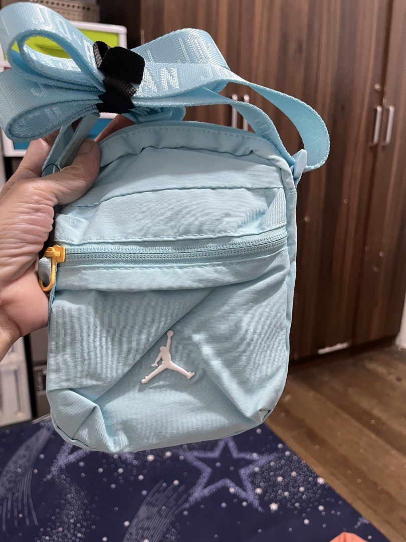 Jordan Crossbody Bag Glacier Ice (Category: Cross-body Bags) located in Pasay City. Submitted by pinedamary44900 (Listing ID 1468050758, Image 1). Description: - Brand: Jordan - Colorway: Glacier Ice (Light Blue) - Condition: Brand new with original store tag attached - Strap: Adjustable with Jordan branding - Pockets: Convenient front zippered pocket with a bright yellow pull tab - Design: Classic white Jumpman logo on the front - Perfect for da