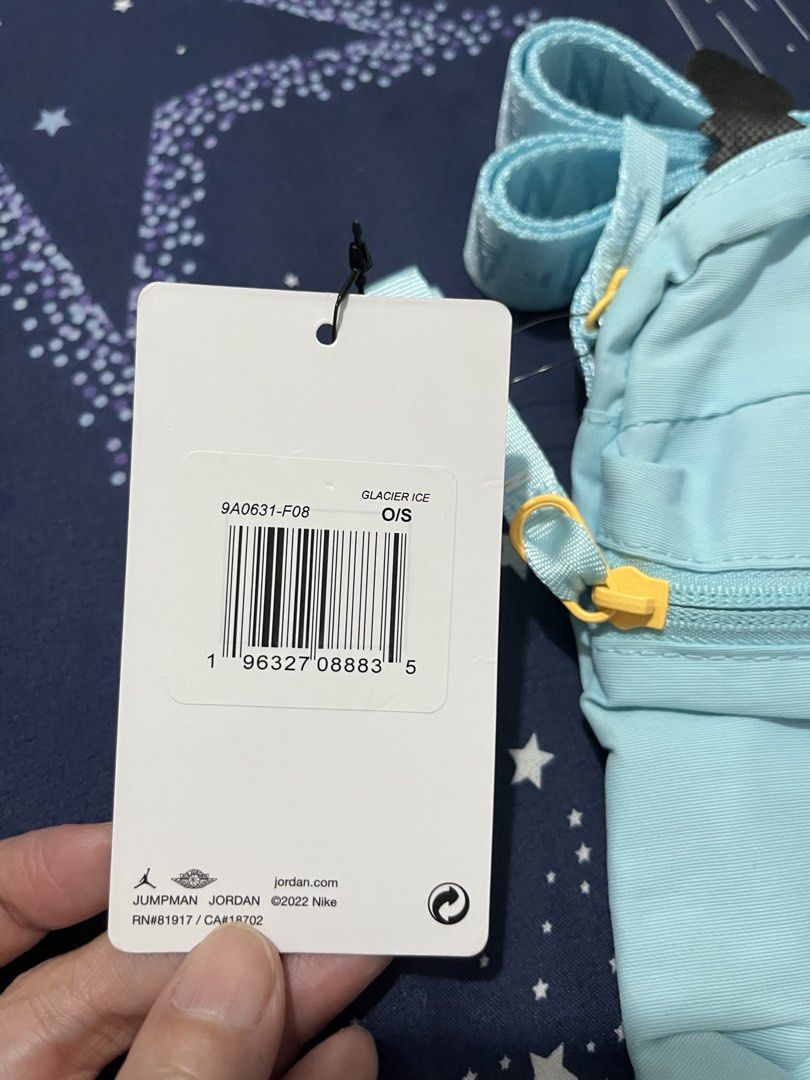 Jordan Crossbody Bag Glacier Ice (Category: Cross-body Bags) located in Pasay City. Submitted by pinedamary44900 (Listing ID 1468050758, Image 2). Description: - Brand: Jordan - Colorway: Glacier Ice (Light Blue) - Condition: Brand new with original store tag attached - Strap: Adjustable with Jordan branding - Pockets: Convenient front zippered pocket with a bright yellow pull tab - Design: Classic white Jumpman logo on the front - Perfect for da