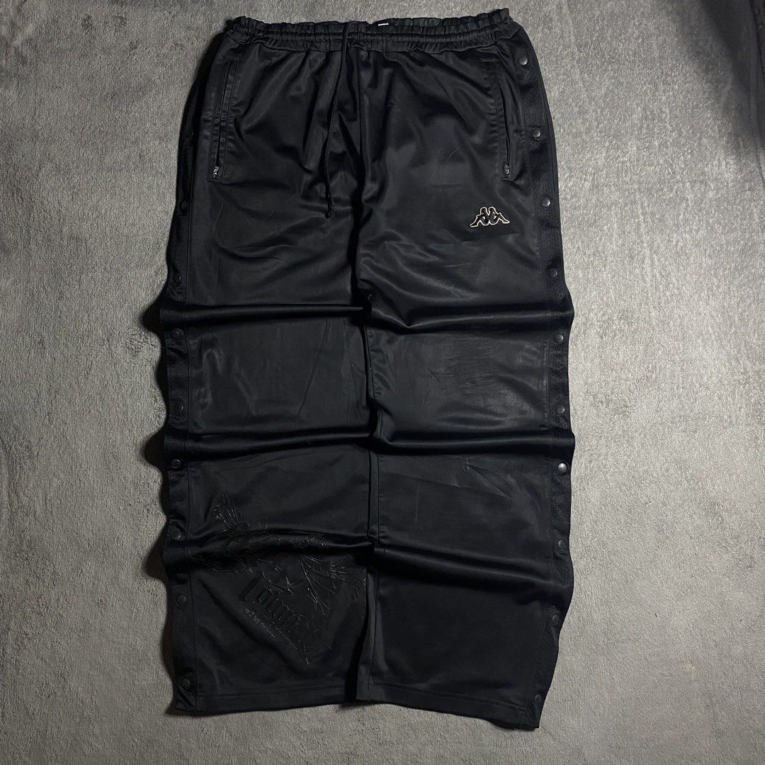 Kappa Black Button-Side Track Pants (Category: Joggers) located in Manila. Submitted by thrifturfit_star (Listing ID 1467846978, Image 1). Description: - Brand: Kappa - Color: Classic Black - Design: Full snap-button sides with subtle left hem graphic - Waistband: Elastic with adjustable drawstring - Pockets: Convenient zippered pockets on both sides - Fit: Relaxed streetwear fit - Material: Smooth, high-quality fabric - Condition: Excellent / Re