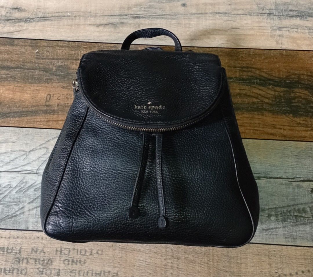 Kate Spade Black Pebbled Leather Medium Backpack (Category: Backpacks) located in Navotas City. Submitted by riyuwi (Listing ID 1467880010, Image 3). Description: PreOwned Lightly Used Authentic Kate Spade New York Pebbled leather Medium Backpack - Material: Premium black pebbled leather - Closure: Flap top with magnetic snap and drawstring cinched main compartment - Interior: Signature spade print lining - Straps: Adjustable shoulder straps with