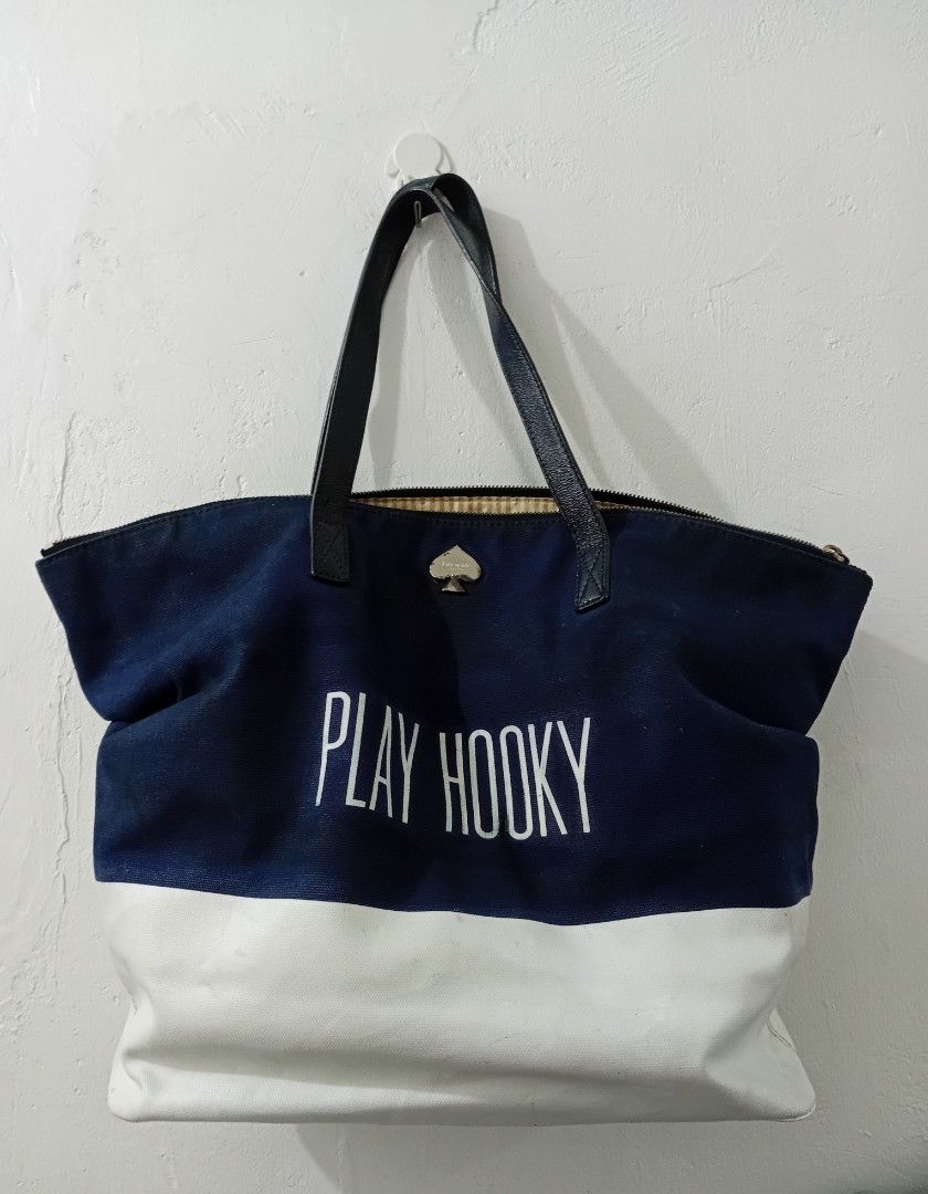 Kate Spade PLAY HOOKY XL TOTEBAG (Category: Luxury Bags & Wallets) located in Manila. Submitted by eriiicaspage (Listing ID 1467038887, Image 1). Description: PREOWNED Lightly Used Authentic Kate Spade Canvas Leather XL totebag - Color/Design: Navy blue and white canvas with 'PLAY HOOKY' print - Straps: Navy blue leather, - Hardware: Signature spade on top center - Closure: Top zip - Interior: Tan and white striped lining with 1 zippered pocket S