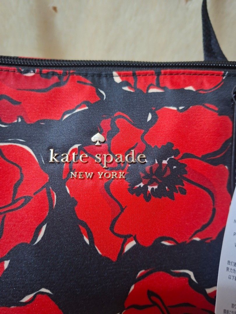 Kate Spade Poppy Printed Packable Tote (Category: Tote Bags) located in Manila. Submitted by yanakolekzione (Listing ID 1468054965, Image 2). Description: Kate Spade packable tote bag in black multi poppy print. Spacious design with sturdy black straps and top zip closure. Packs down into its own attached pouch for easy travel and storage. Original retail tag attached showing USD 299.00 value. Made in Philippines..