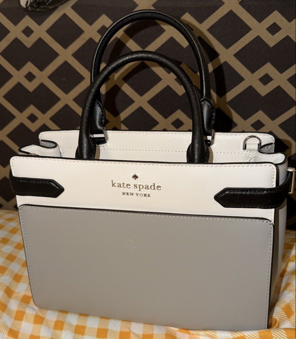 Kate Spade Staci Medium Satchel Nimbus Grey (Category: Tote Bags) located in Manila. Submitted by nayeoniescart (Listing ID 1468030164, Image 1). Description: BRAND NEW: Kate Spade Staci Medium Satchel - Colorway: Nimbus Grey, White, and Black Colorblock - Material: Premium Saffiano Leather - Hardware: Gold-tone with logo lettering - Condition: Brand new with original tags attached (Model WKRU6952) - Features: Dual top handles, structured silhoue