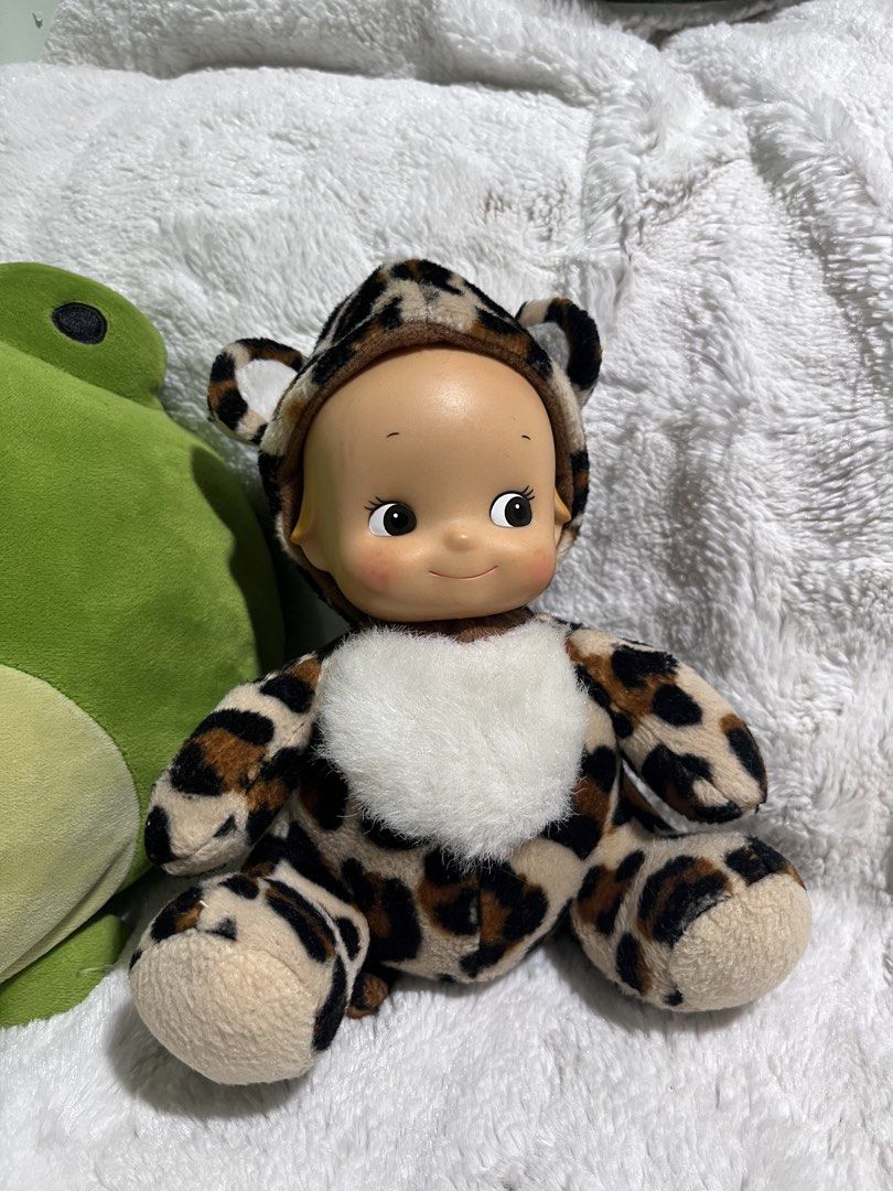 Kewpie Tokyo Mimore Doll (Category: Plushies & Soft Toys) located in Zamboanga. Submitted by wilthearey91043 (Listing ID 1467982367, Image 1). Description: - Brand: Tokyo Mimore - Design: Plush doll with a vinyl bald head and soft leopard print body - Features: Hood with animal ears, fuzzy white chest patch, and molded hair detail at the back - Condition: Pre-loved, well-maintained with intact brand tag - Origin: Made in China.