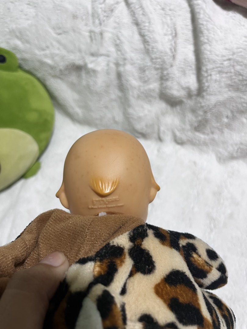 Kewpie Tokyo Mimore Doll (Category: Plushies & Soft Toys) located in Zamboanga. Submitted by wilthearey91043 (Listing ID 1467982367, Image 2). Description: - Brand: Tokyo Mimore - Design: Plush doll with a vinyl bald head and soft leopard print body - Features: Hood with animal ears, fuzzy white chest patch, and molded hair detail at the back - Condition: Pre-loved, well-maintained with intact brand tag - Origin: Made in China.