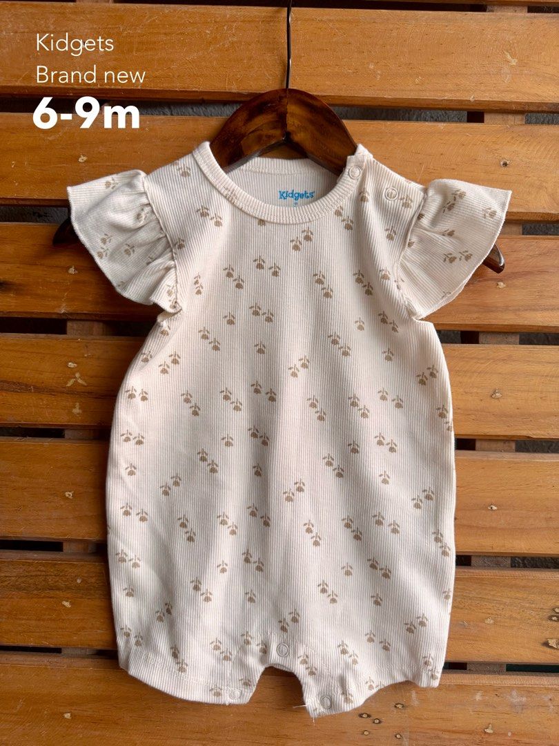 Kidgets Baby Girl Rompers (Category: Babies & Kids Fashion) located in Santa Rosa. Submitted by yasss23 (Listing ID 1467982441, Image 3). Description: - Brand: Kidgets - Item: Bundle of baby girl rompers - Designs: Assorted cute prints (flowers, hearts, leopard print) - Features: Short sleeves, ruffled shoulders, snap buttons for easy diaper changes - Material: Soft and comfortable cotton, ideal for everyday wear - Sizes: Ranges from 0-3 months u