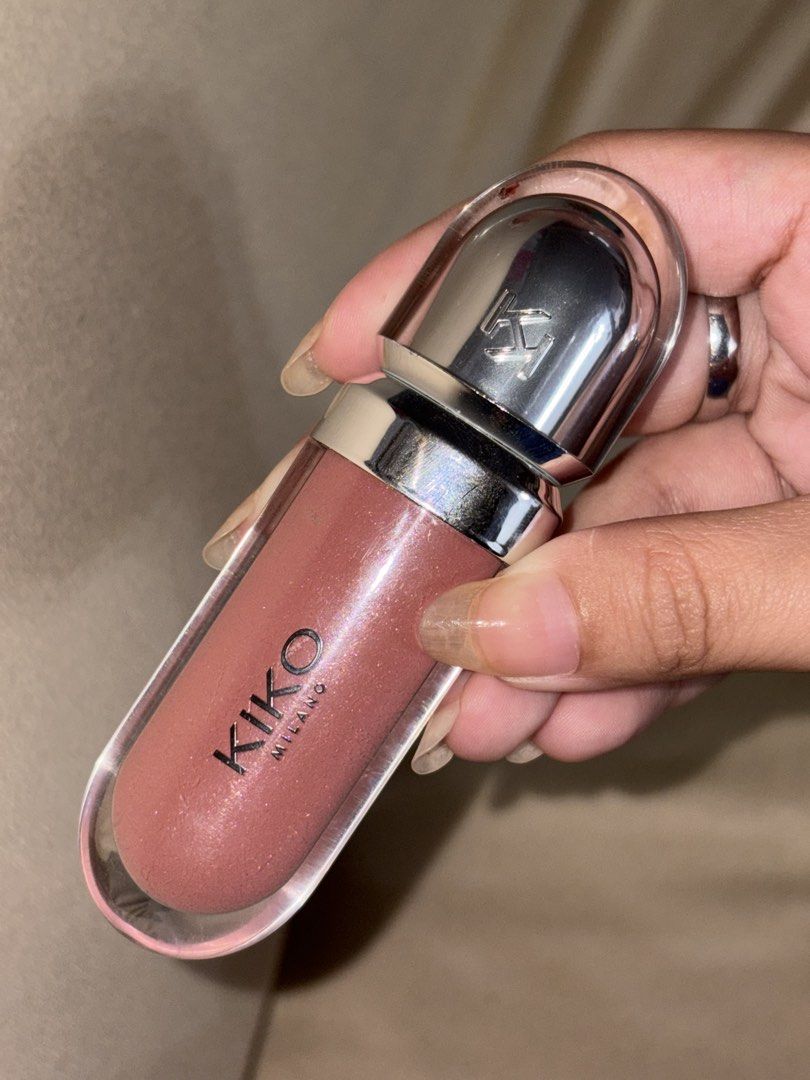 Kiko Milano Lip Gloss (Category: Makeup) located in Taguig. Submitted by idkdm (Listing ID 1467962286, Image 1). Description: - Brand: Kiko Milano 3D Lip Gloss #20 - Shade: Shimmery pink with fine glitter - Packaging: Clear tube with a stylish silver cap featuring the embossed Kiko logo - Size: Handy and pocket-friendly for easy on-the-go touch-ups.