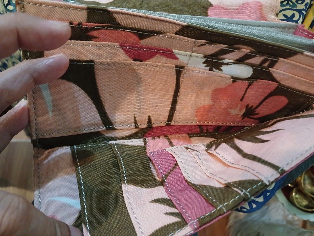 Kipling floral print long canvas wallet (Category: Wallets & Card holders) located in Marikina City. Submitted by laila15 (Listing ID 1467970599, Image 2). Description: - Authentic Kipling long wallet - Stylish brown, pink, and white floral canvas print - Secure snap button closure - Multiple card slots and clear ID windows - Convenient interior zippered coin compartment - Spacious design easily holds bills and cards - Durable fabric construction
