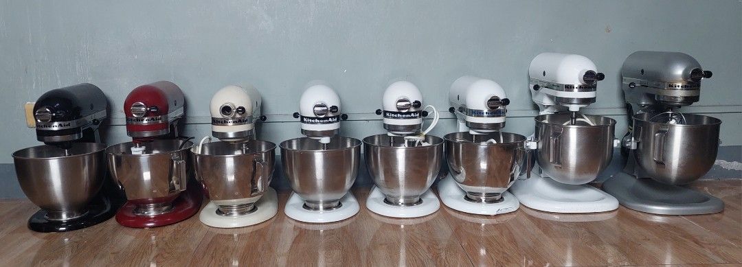 KitchenAid Stand Mixer Collection Multiple Models Available (Category: Hand & Stand Mixers) located in Pasig City. Submitted by brightocean_bb44a1 (Listing ID 1467977216, Image 1). Description: Variety of KitchenAid stand mixers lined up in different colors and capacities. Includes black, red, cream, white, silver, and grey units. Several bowls, wire whips, flat beaters, and dough hooks included across the lineup. Multiple motor sizes and power r