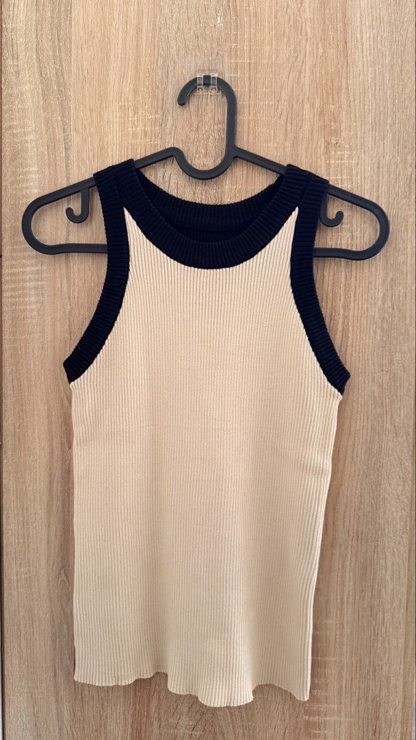 Knit Tank Top – Cream & Black (Category: Sleeveless) located in Santa Rosa. Submitted by stealbydiva (Listing ID 1467905366, Image 1). Description: - Style: Two-tone knit tank top (Cream front, back) - Details: Contrast black ribbing on neckline and armholes - Fit & Material: Stretchy ribbed fabric, comfortable fit - Length: Approx. 54 cm - Condition: Clean and well-maintained.