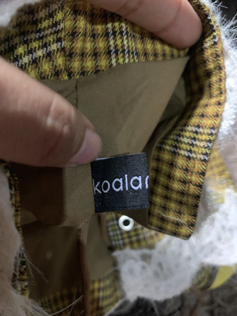 Koalar Yellow Plaid Corset Top (Category: Sleeveless) located in Cebu City. Submitted by selamethrift (Listing ID 1467950728, Image 2). Description: - Brand: Koalar - Design: Yellow plaid corset top with brown faux leather trim and cute front bow detail - Hem: White fluffy lace trim along the bottom - Closure: Front lace-up design with separate brown cords included - Interior: Fully lined with brown fabric for comfort.