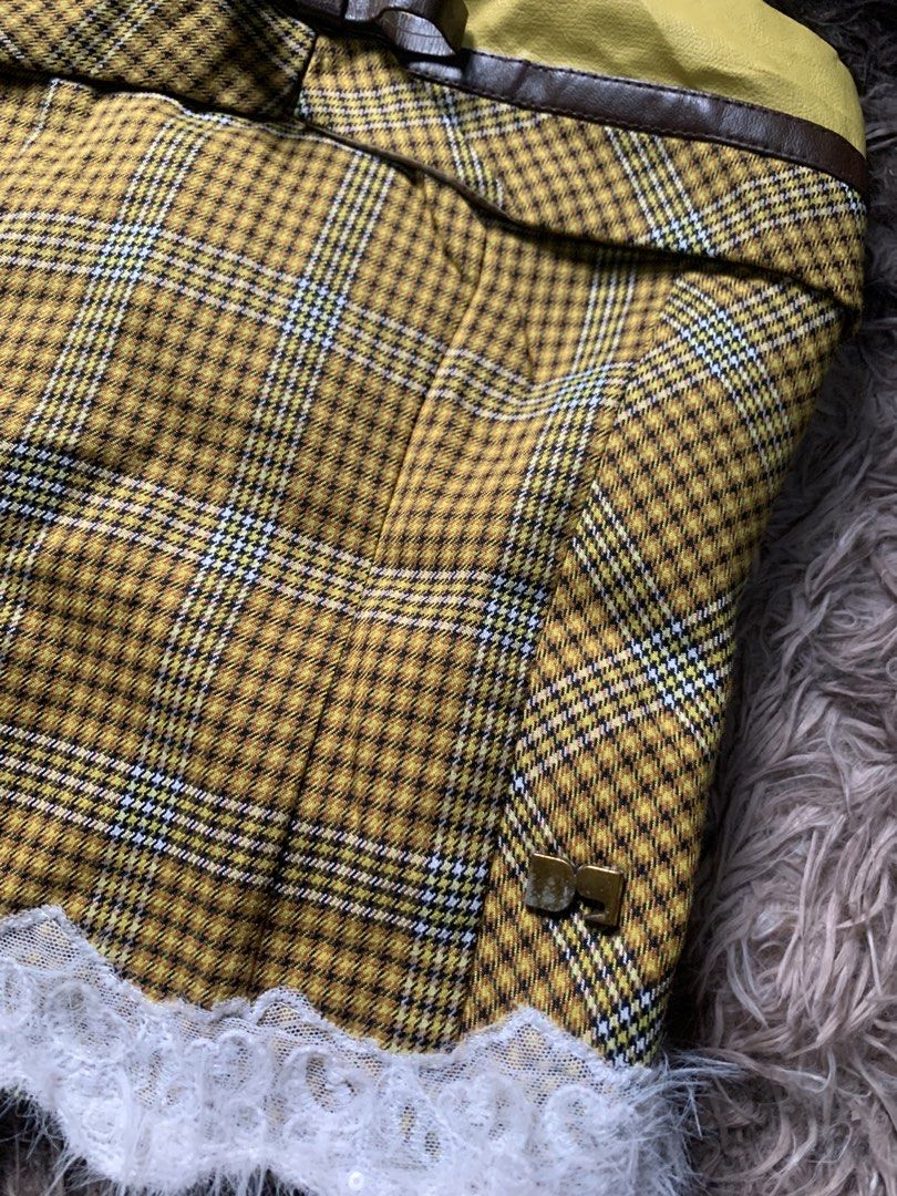 Koalar Yellow Plaid Corset Top (Category: Sleeveless) located in Cebu City. Submitted by selamethrift (Listing ID 1467950728, Image 3). Description: - Brand: Koalar - Design: Yellow plaid corset top with brown faux leather trim and cute front bow detail - Hem: White fluffy lace trim along the bottom - Closure: Front lace-up design with separate brown cords included - Interior: Fully lined with brown fabric for comfort.