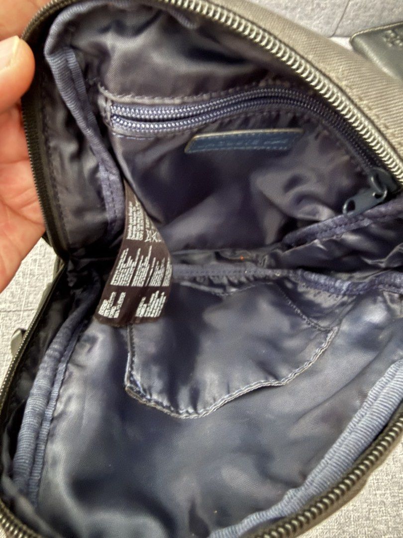 Lacoste Black Crossbody Sling Bag (Category: Sling Bags) located in Pasay City. Submitted by el.sole (Listing ID 1467530605, Image 3). Description: 👉FREE SHIPPING!!! (Within MetroManila Only) 👉FREE SHIPPING!!! (Luzon,Visayas and Mindanao) via J&T or LBC 👉Repriced: May natanggal na bilog (please see photo in red circle and arrow). See photo. But in good condition in the bag. - Brand: Lacoste - Color: Classic Black - Design: Compact crossbody ba
