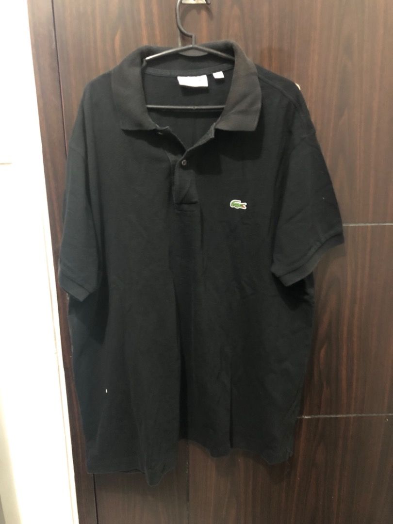 Lacoste Black Polo Shirt (Category: Tshirts & Polo Shirts ) located in Manila. Submitted by kissa.1890 (Listing ID 1468049579, Image 1). Description: - Brand: Lacoste - Color: Solid black - Design: Short sleeves, standard collar with a two-button placket - Detail: Iconic embroidered green crocodile logo on the left chest - Fit/Style: Classic casual everyday wear - Condition: Excellent / Pre-loved (ready to wear).
