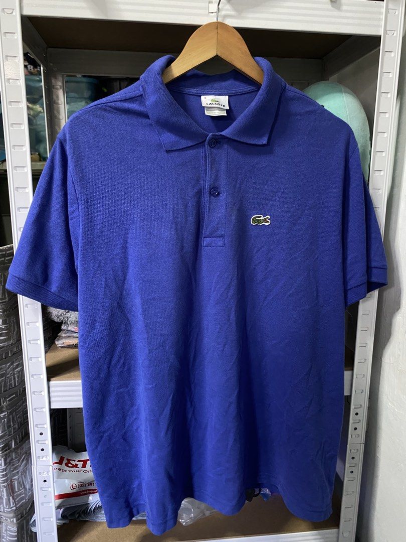 Lacoste Blue Polo Shirt Size 6 (Category: Tshirts & Polo Shirts ) located in Manila. Submitted by kuya_moto (Listing ID 1467889299, Image 1). Description: - Brand: Lacoste - Color: Blue - Size: 6 - Material: 100% cotton with a breathable weave - Design: Classic collar, button placket, and short sleeves - Logo: Iconic embroidered green crocodile on the chest - Origin: Designed in France, made in El Salvador - Condition: Clean stitching throughout,