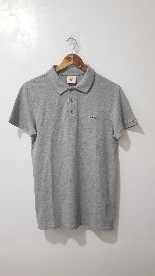 Lacoste Live Grey Polo Shirt Size 2 (Category: Tshirts & Polo Shirts ) located in Manila. Submitted by nice430 (Listing ID 1467895419, Image 1). Description: - Brand: Lacoste Live - Color: Grey - Size: 2 (Style No: PH4769K1) - Fit: Normal fit, classic casual everyday wear - Details: Short sleeves, classic collar, three-button placket - Logo: Small embroidered green crocodile on chest - Condition: Clean fabric, well-maintained.