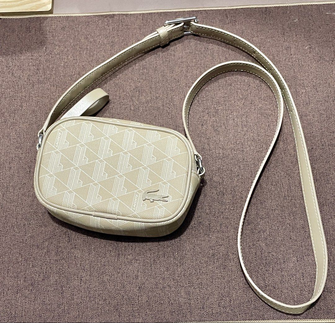 Lacoste Monogram Crossbody Bag - Beige (Category: Cross-body Bags) located in Quezon City. Submitted by cosmicbear-8455 (Listing ID 1467965470, Image 3). Description: - Brand: Lacoste - Color: Beige with all-over geometric monogram print - Design: Compact rectangular shape - Strap: Adjustable matching leather strap with a silver-tone buckle - Condition: Clean structure, ideal everyday staple size A lovely beige Lacoste Monogram Crossbody Bag in l