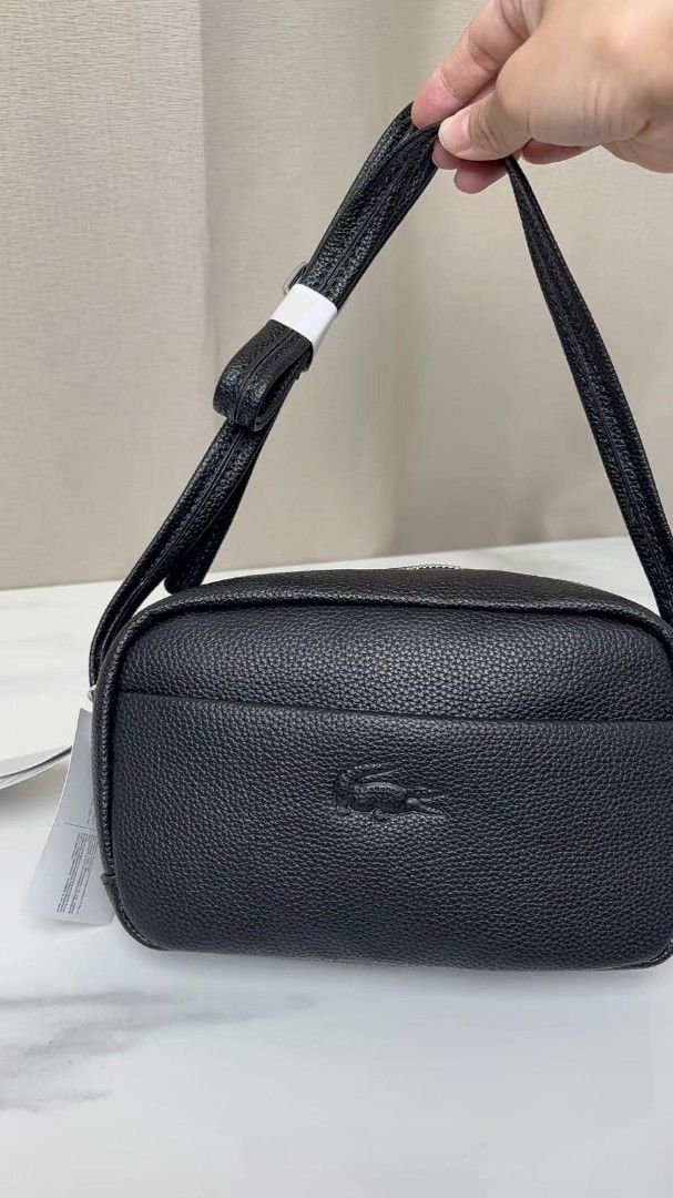 Lacoste Pebble Grain Leather Crossbody Bag (Category: Cross-body Bags) located in Caloocan City. Submitted by luckyocean_e40f38 (Listing ID 1467863718, Image 2). Description: - Material: Premium pebbled leather with clean stitching - Design: Structured rectangular shape with iconic embossed crocodile logo - Closure: Secure top zipper closure - Compartments: Handy front slip pocket for easy access - Strap: Adjustable strap for a comfortable, custo