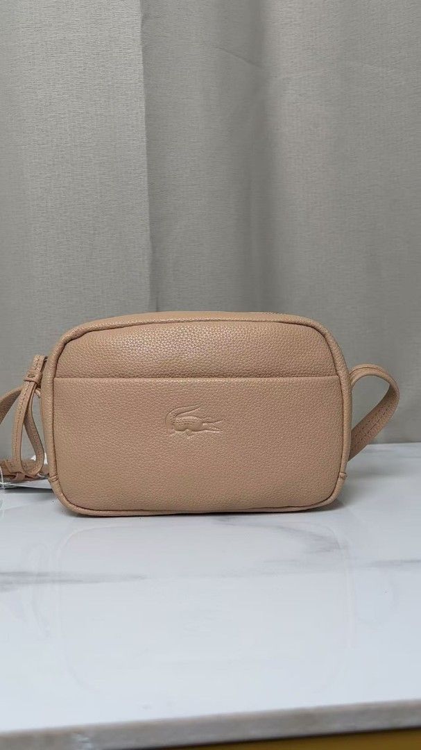 Lacoste Pebble Grain Leather Crossbody Bag (Category: Cross-body Bags) located in Caloocan City. Submitted by luckyocean_e40f38 (Listing ID 1467863718, Image 1). Description: - Material: Premium pebbled leather with clean stitching - Design: Structured rectangular shape with iconic embossed crocodile logo - Closure: Secure top zipper closure - Compartments: Handy front slip pocket for easy access - Strap: Adjustable strap for a comfortable, custo