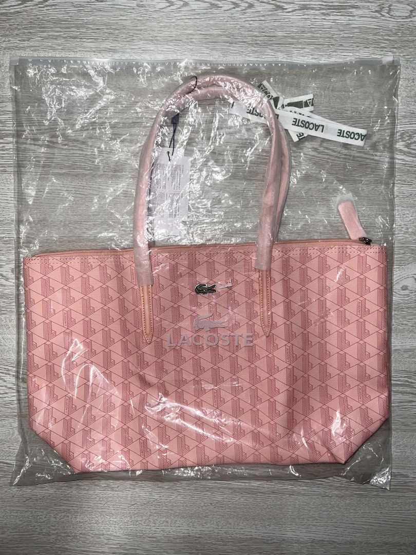 Lacoste Pink Geometric Tote Bag (Category: Tote Bags) located in Quezon City. Submitted by callist0 (Listing ID 1467980611, Image 1). Description: Pink Lacoste tote bag with a geometric monogram pattern throughout. Dual shoulder straps, top zipper closure, and front logo text with crocodile emblem. Tags still attached, packed inside the original clear plastic bag. price is firm. Location: San Juan, Metro Manila NO REFUND POLICY.