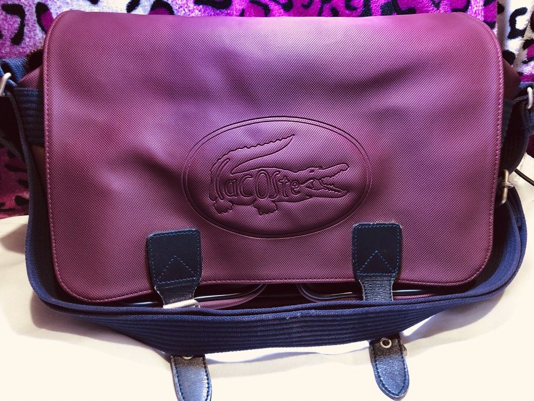 Lacoste Yellow Canvas Backpack with Embossed Crocodile Logo (Category: Backpacks) located in Malabon City. Submitted by jillmolo (Listing ID 1467960984, Image 2). Description: TAKE ALL Bright yellow Lacoste backpack made from sturdy canvas material. Features an embossed crocodile logo inside an oval patch on the front pocket. Flap closure with adjustable metal buckle strap. Dark blue strap and bottom panel contrast nicely against the yellow fabri