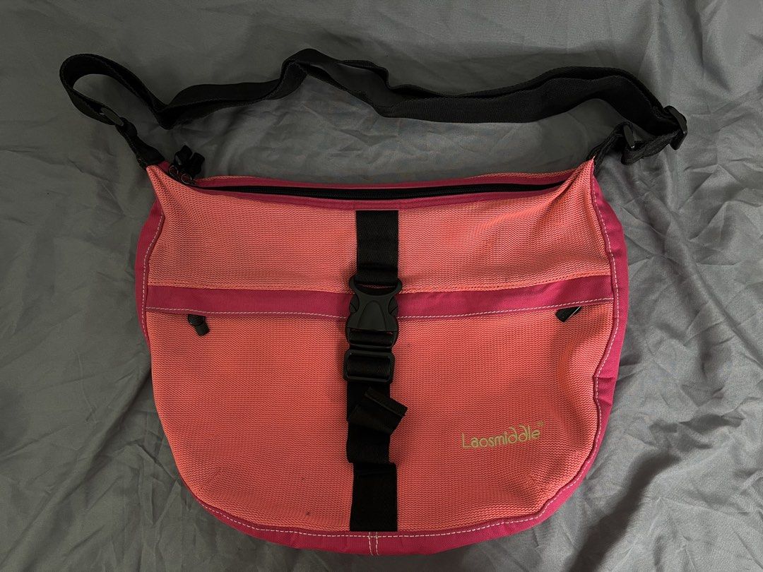 Laosmiddle Pink Messenger Bag with Buckle Strap (Category: Cross-body Bags) located in Imus. Submitted by graeyowl (Listing ID 1467947669, Image 1). Description: Item Description: • Brand: Laosmiddle • Style: Crossbody Messenger / Sling Bag • Material: Durable woven nylon mesh and canvas • Color: Bright Coral Pink / Hot Pink / Black Accents • Closure: Large adjustable center strap with a heavy-duty quick-release plastic buckle • Pockets: Easy-acc