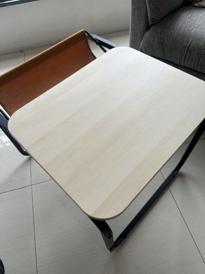 IKEA OLSERÖD Side table / Laptop / coffee table dual height with catch tray (Category: Tables & Sets) located in Quezon City. Submitted by dlsy12 (Listing ID 1467930624, Image 3). Description: - Compact accent table with a stylish light wood-grain top and sturdy black metal frame - Features a built-in brown fabric sling pocket at the back for storing magazines and small items - Ideal for small spaces in the living room, bedroom, or study area - C