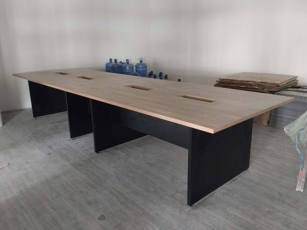 Large Wooden Conference Table with Cable Management (Category: Tables & Sets) located in Caloocan City. Submitted by jim.trishtineofficefurnitures (Listing ID 1467921304, Image 3). Description: - Type: Extra long meeting table - Aesthetics: Light woodgrain top with dark sturdy panel legs - Features: Multiple built-in wire management cutouts along the center - Capacity: Seats a large team comfortably - Condition: Clean surface, no major scratches 