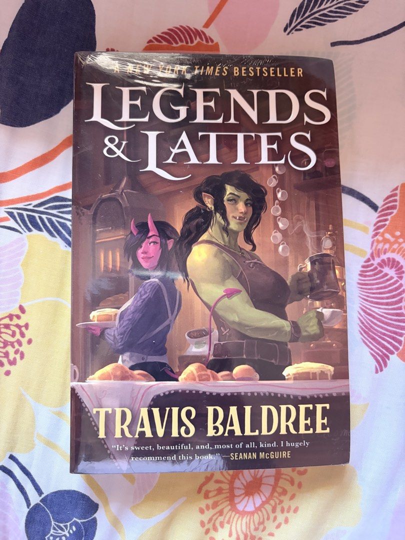Legends & Lattes by Travis Baldree (Category: Storybooks) located in Tarlac. Submitted by noveliaph (Listing ID 1467867837, Image 1). Description: - Title: Legends & Lattes by Travis Baldree - Edition: Tor paperback (New York Times bestseller cover) - Condition: Brand new, still sealed in original plastic wrap (Unread) - Genre: High fantasy / Low stakes cozy read - Plot: An orc retires from adventuring to open the very first coffee shop in a fant