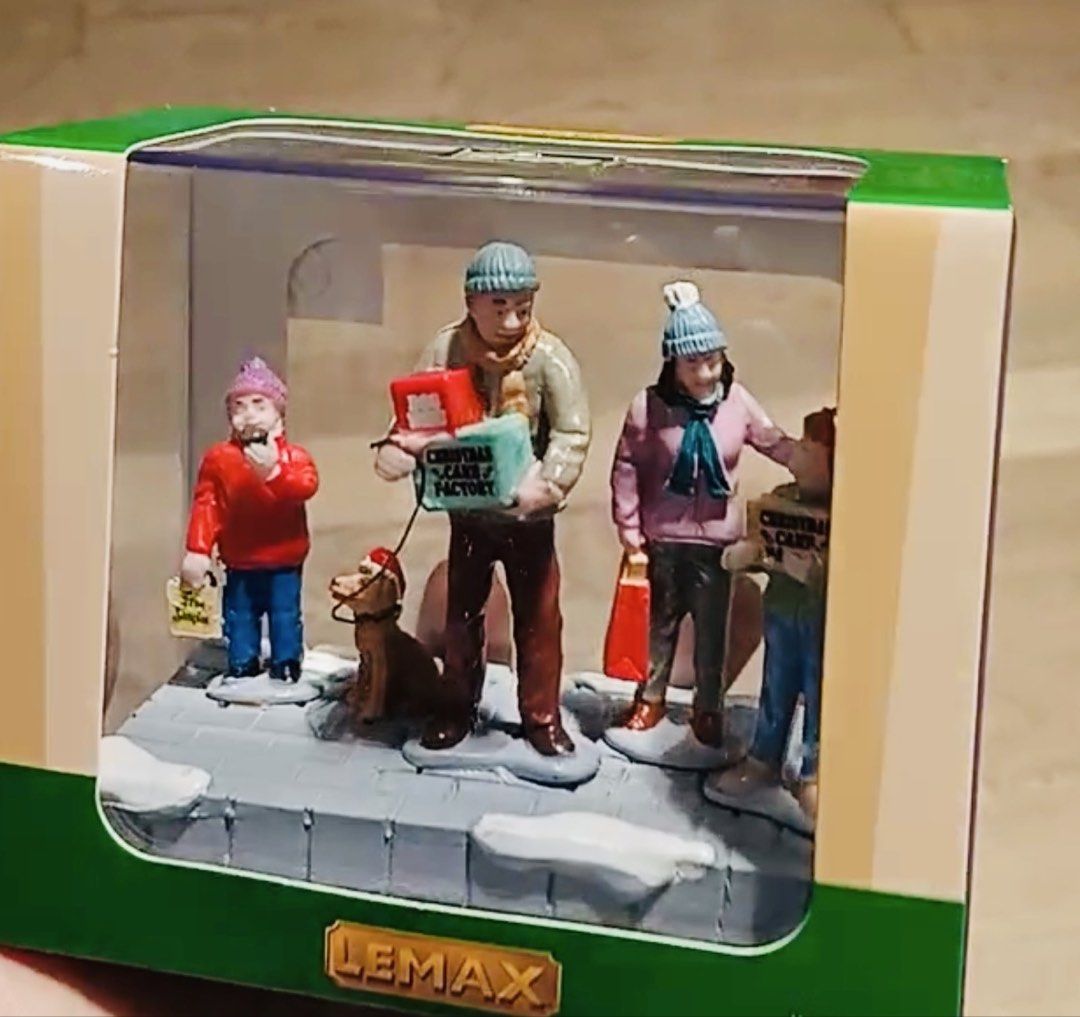 Lemax Cake Shopping (Category: Figurines & Statues) located in Quezon City. Submitted by cheap_cheaper (Listing ID 1468032095, Image 2). Description: - Brand: Lemax Christmas Village - Piece Name: Cake Shopping - Design: Family members and a cute dog carrying shopping bags and presents on a snowy sidewalk base - Condition: Brand new in original, unopened box - Perfect for holiday display setups and collectors.