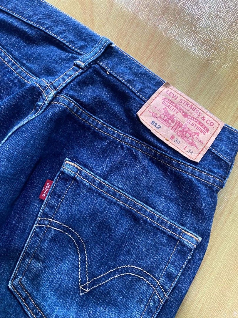 Levi's 512 (Category: Jeans) located in Tandag. Submitted by vncntmrcllns (Listing ID 1467922592, Image 3). Description: Waist: 30 Length: 43 - Brand: Levi's - Style: 512 Straight Leg - Size: W30 L34 - Wash: Dark wash / Clean indigo with minimal fading - Closure: Button fly - Details: Traditional orange stitching, copper rivets, iconic leather back waistband patch, and red tab on the right back pocket - Condition: Excellent, well-maintained.