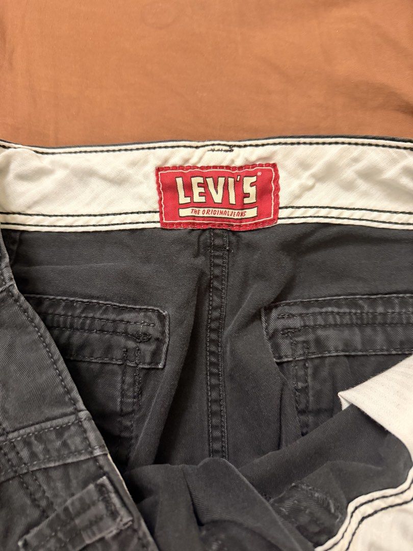 Levi's Cargo Shorts Black W36 (Category: Shorts) located in Manila. Submitted by ruroocu (Listing ID 1467966311, Image 1). Description: - Brand: Levi's - Style: Men's cargo shorts - Color: Washed Black - Size: W36 - Material: 100% cotton (Made in Egypt) - Fit: Relaxed fit for daily casual wear - Pockets: Multiple utility pockets with button flaps and metal grommets - Closure: Button fly - Details: Classic Levi's branding tag on the back pocket an