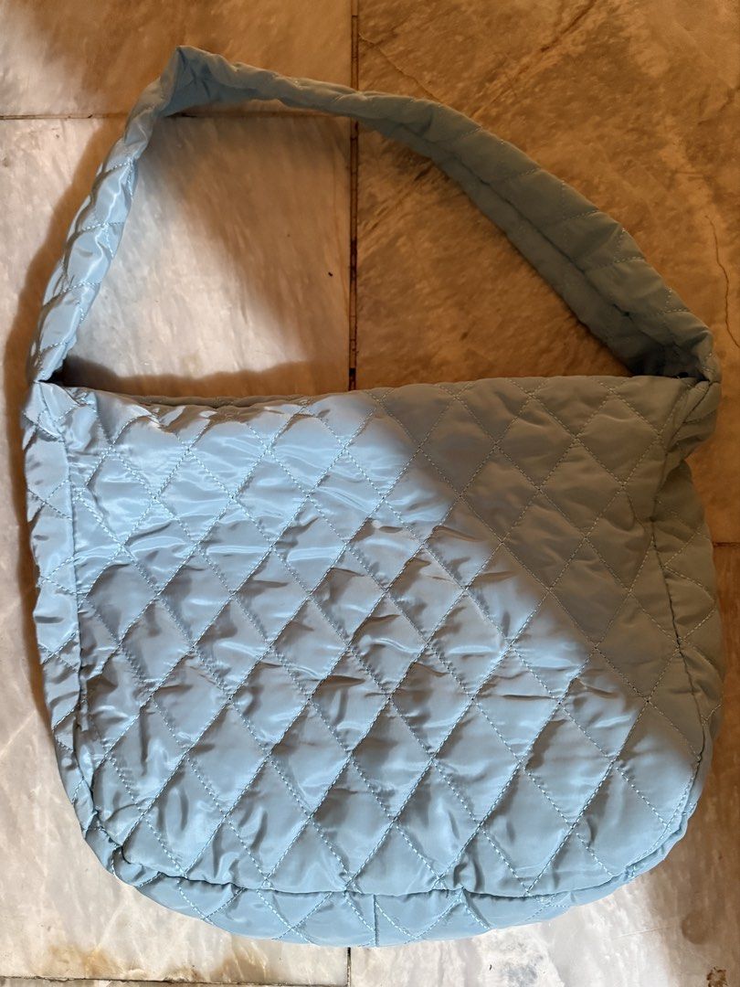 light blue quilted shoulder cloud bag with zipper (Category: Shoulder Bags) located in Quezon City. Submitted by riexomt (Listing ID 1467921201, Image 2). Description: - light blue soft quilted nylon bubble cloud bag - gold zipper with dark grey lining - no inner pockets - very spacious and fits 13” laptop - package from brand.