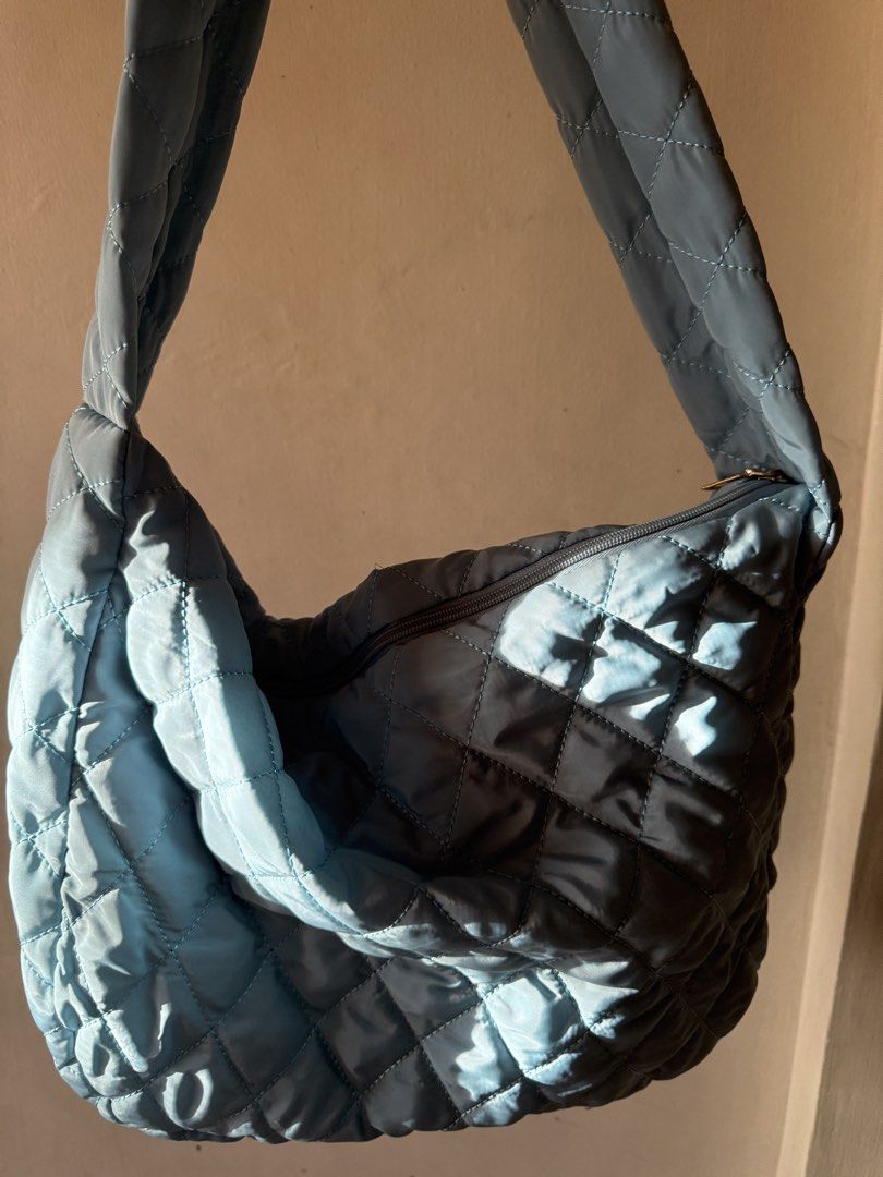 light blue quilted shoulder cloud bag with zipper (Category: Shoulder Bags) located in Quezon City. Submitted by riexomt (Listing ID 1467921201, Image 1). Description: - light blue soft quilted nylon bubble cloud bag - gold zipper with dark grey lining - no inner pockets - very spacious and fits 13” laptop - package from brand.