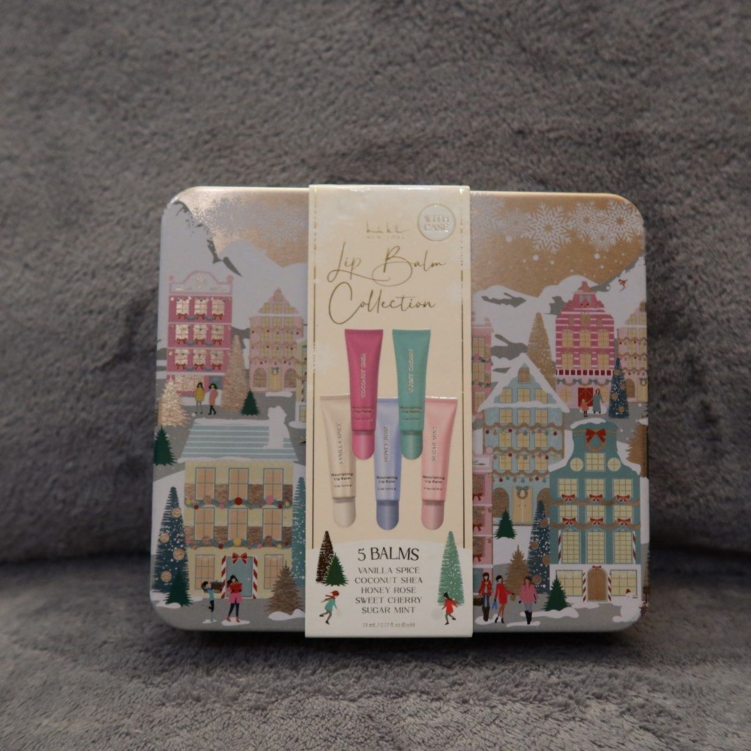 Lip Balm Collection 5-Piece Tin Set (Category: Makeup) located in Manila. Submitted by gentlewind_62f064 (Listing ID 1467925498, Image 1). Description: - Brand new, unopened holiday lip balm set in a decorative metal tin - Features a charming festive winter village illustration - Set of 5 delicious flavors: Vanilla Spice, Coconut Shea, Honey Rose, Sweet Cherry, and Sugar Mint - Generous size: 11 mL per tube - Ready for gifting, perfect for the ho