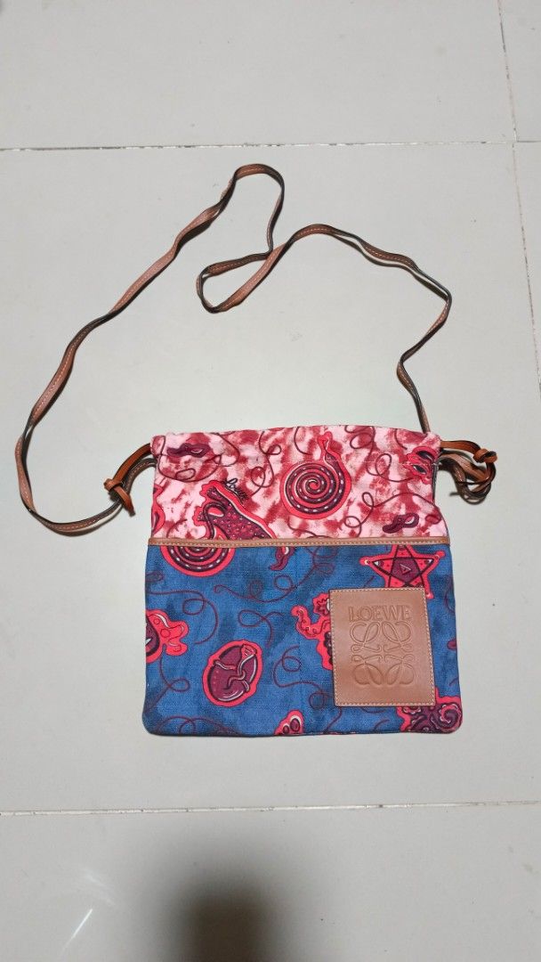 Loewe Canvas Bag (Category: Cross-body Bags) located in Manila. Submitted by zariyah.1986 (Listing ID 1467965903, Image 1). Description: Loewe bag canvas fabric with abstract graphic prints. Brown leather patch with embossed Loewe Anagram logo on the front. Includes a thin brown leather strap and drawstring style closure. .