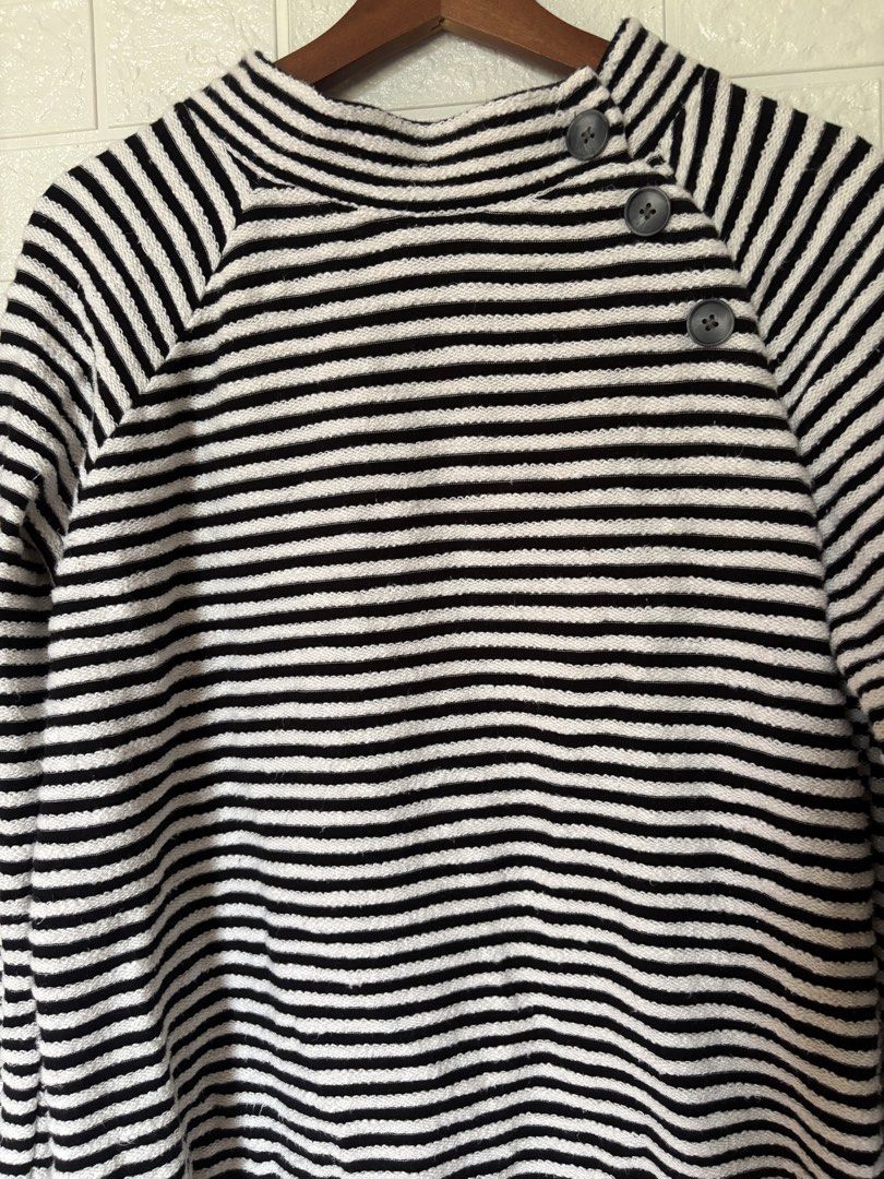 LOFT Black and White Striped Button-Neck Sweater Size M (Category: Longsleeves) located in Batangas. Submitted by purple_and_orange (Listing ID 1467862863, Image 2). Description: - Brand: LOFT - Style: Black and white striped sweater with mock neck - Detail: Three decorative buttons on the side shoulder - Material: 100% breathable cotton knit - Fit: Relaxed fit with long sleeves - Size: M - Care: Machine washable - Origin: Made in India.