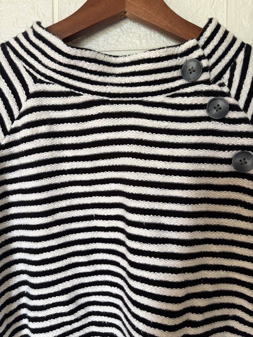 LOFT Black and White Striped Button-Neck Sweater Size M (Category: Longsleeves) located in Batangas. Submitted by purple_and_orange (Listing ID 1467862863, Image 3). Description: - Brand: LOFT - Style: Black and white striped sweater with mock neck - Detail: Three decorative buttons on the side shoulder - Material: 100% breathable cotton knit - Fit: Relaxed fit with long sleeves - Size: M - Care: Machine washable - Origin: Made in India.