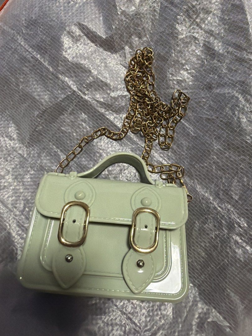 London Rag Mint Jelly Saddle Sling Bag (Category: Cross-body Bags) located in Manila. Submitted by bitski (Listing ID 1467969084, Image 1). Description: - Color: Mint green - Material: Jelly - Hardware: Gold-tone with chain strap - Style: Structured satchel with double buckle front flap - Closure: snapon Rfs : decluttering.