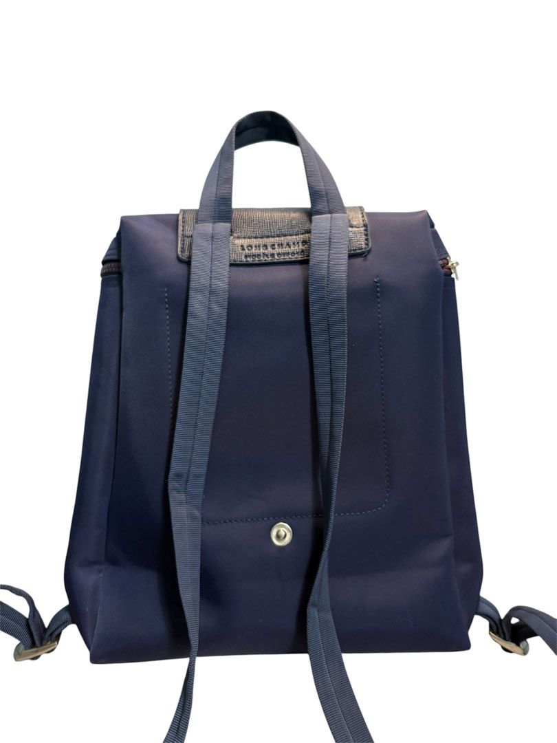 Longchamp Le Pliage Backpack Navy Blue (Category: Backpacks) located in Cagayan de Oro. Submitted by thatsdopethrift (Listing ID 1467881734, Image 2). Description: The bag features water-resistant recycled nylon canvas and matching leather trim. Please note that the round metallic jockey pull charm is missing from the slider loop, but the zipper mechanism remains fully smooth and operational. • Base Width: 10.2 inches (26 cm) • Height: 11.0 inche