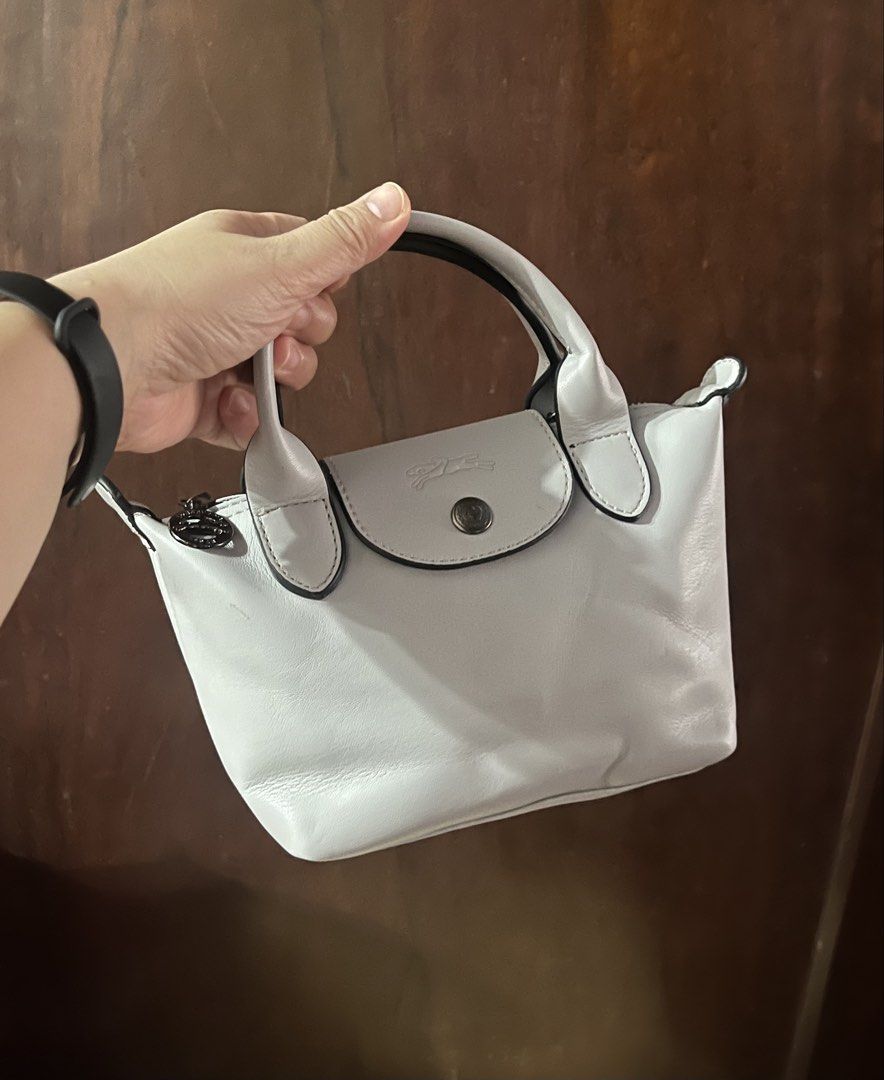 Longchamp Le Pliage Cuir Extra Small Top Handle Bag (Category: Luxury Bags & Wallets) located in Manila. Submitted by pickandgo26 (Listing ID 1467862286, Image 1). Description: Condition: Compact size with minor scuff on one handle edge and a small scratch at the back, missing sling. With jelly tag inside. Not guaranteed. Still nego Pls see actual photos for reference..