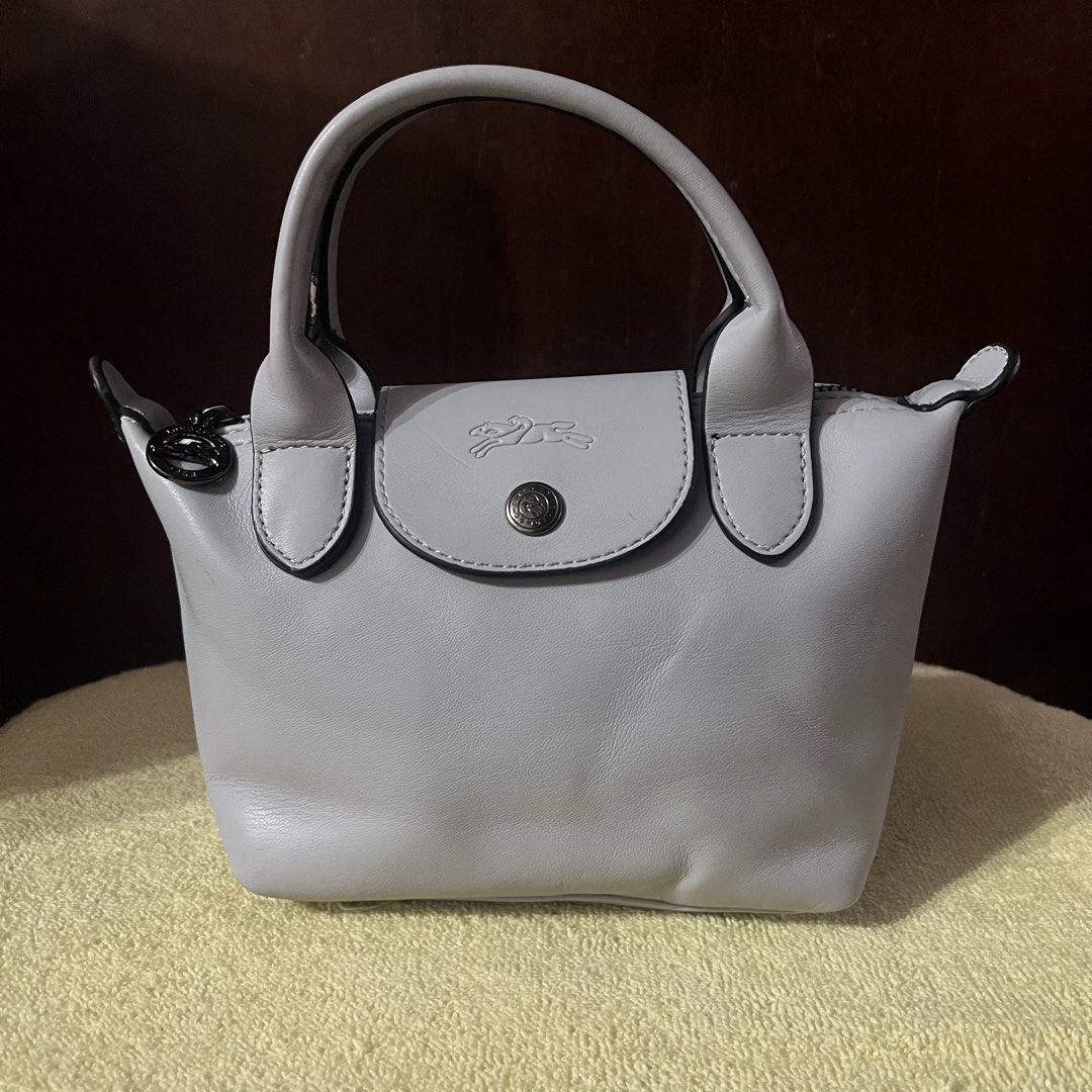 Longchamp Le Pliage Cuir Extra Small Top Handle Bag (Category: Luxury Bags & Wallets) located in Manila. Submitted by pickandgo26 (Listing ID 1467862286, Image 2). Description: Condition: Compact size with minor scuff on one handle edge and a small scratch at the back, missing sling. With jelly tag inside. Not guaranteed. Still nego Pls see actual photos for reference..