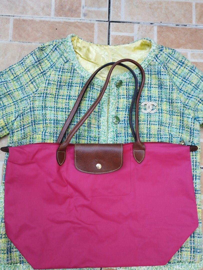 Longchamp Le Pliage Long Handle Tote Bag Pink (Category: Luxury Bags & Wallets) located in Manila. Submitted by beckster_nnline_luxuryshop (Listing ID 1467911751, Image 2). Description: Bright pink Longchamp nylon tote with brown leather handles and flap. Zip top closure with snap button detail. Classic everyday shoulder bag size. Measurements shown in pictures with tape measure. Clean fabric exterior and structured base. Great daily commuter or 